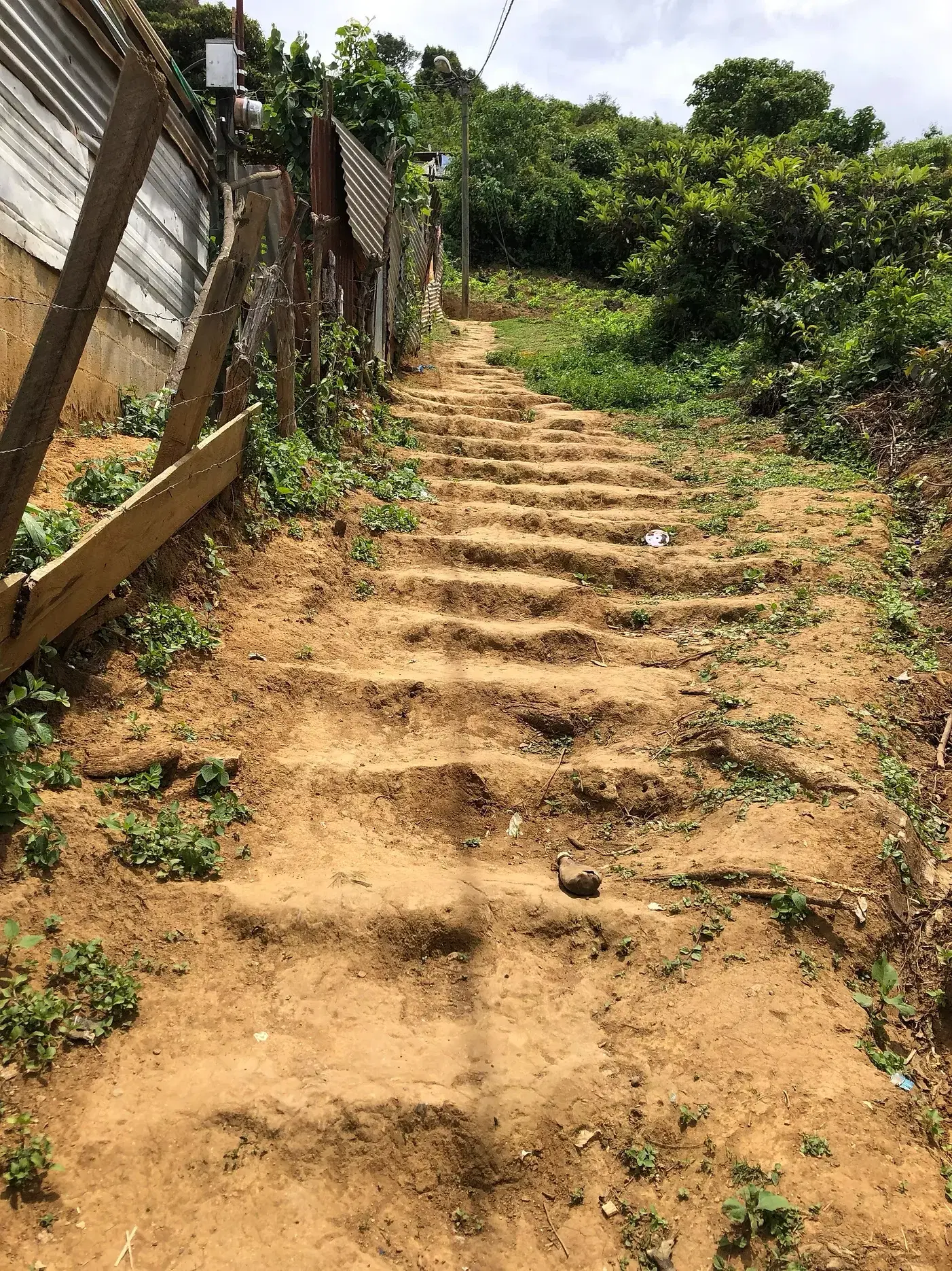 Earthen steps climbing between homes in Aguacate