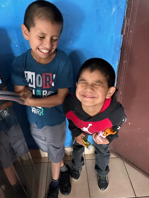 Two boys sharing a laugh at the home