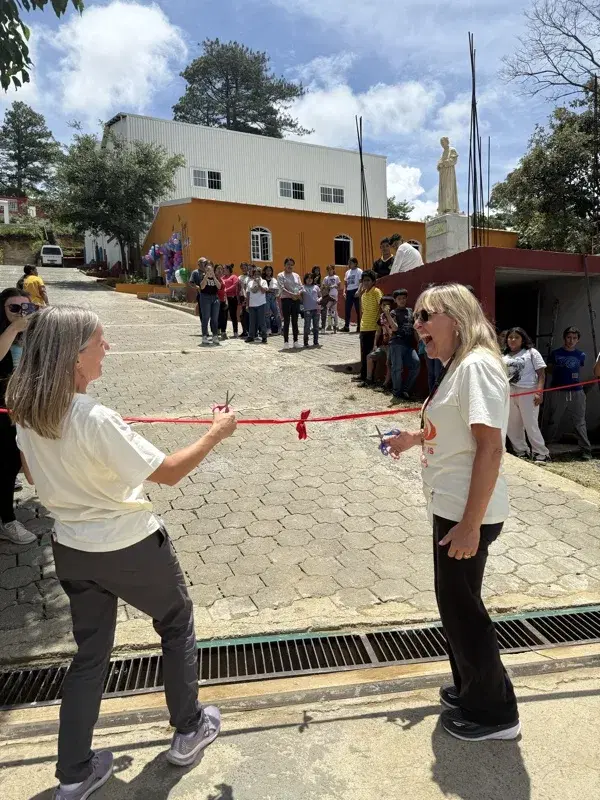 Cutting the ribbon at the trade school dedication