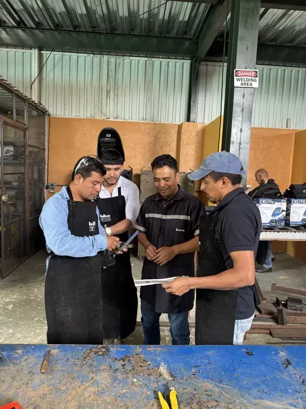 Welding students reviewing plans in the new shop