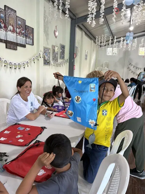A boy showing off his name on a VBS gift bag